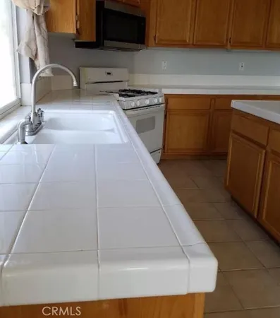 a kitchen with a sink and a stove top oven