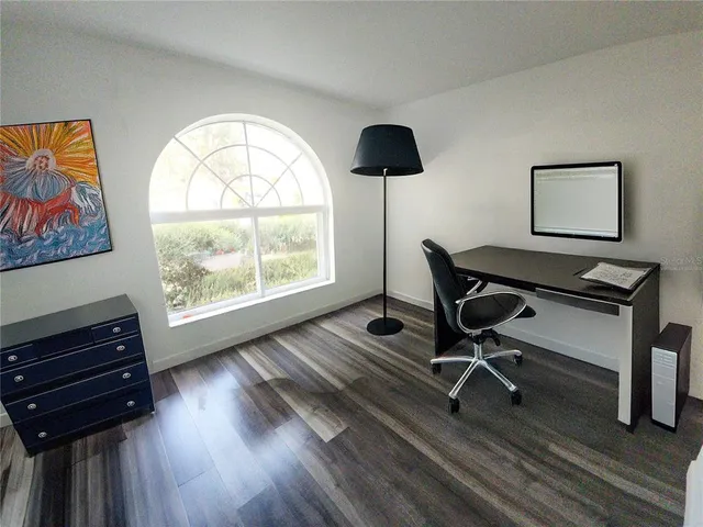 a view of a livingroom with furniture and a window