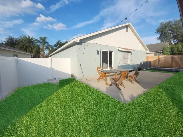 a view of a backyard with sitting area