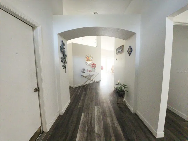 a view of a hallway view with wooden floor and staircase