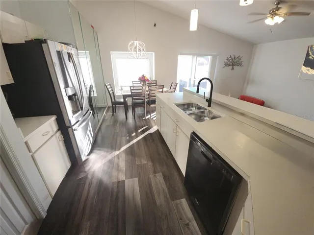 a kitchen with sink a refrigerator and a stove