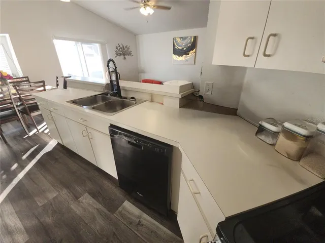a kitchen with sink refrigerator and window