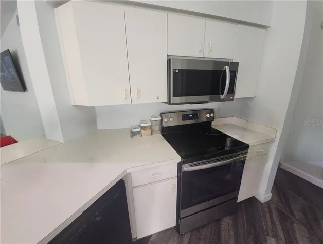 a kitchen with a stove and a microwave