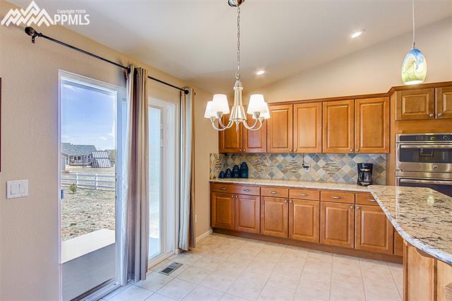 8643 Del Rio Road Peyton, CO 80831 - Photo 11 of 35 Kitchen with buffet and walk out to back patio.