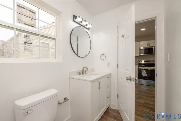 a bathroom with a toilet a sink and a mirror