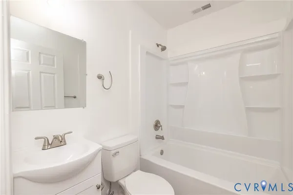 a bathroom with a bathtub shower sink and toilet