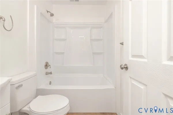 a bathroom with a toilet and a bathtub
