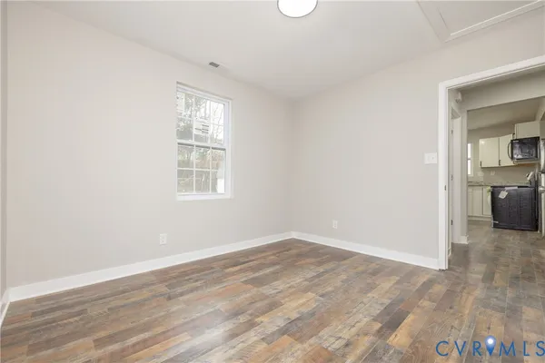 wooden floor in an empty room with a window