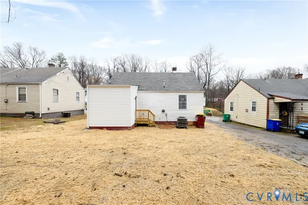 a view of a house with a yard covered in snow