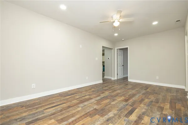 a view of an empty room with a ceiling fan