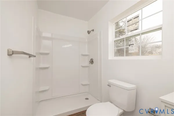 a white toilet sitting next to a bathroom sink