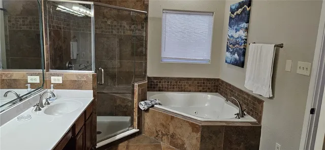 a bath tub sitting next to a bathroom sink