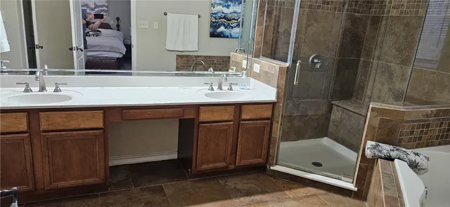 a bathroom with a sink a mirror and shower