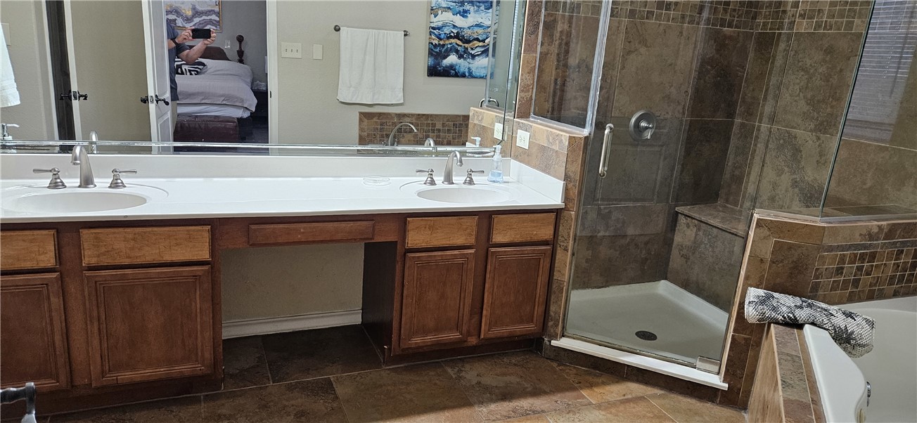 14334 Cruiser Street, Unit 202A Corpus Christi, TX 78418 - Photo 19 of 38 a bathroom with a sink a mirror and shower