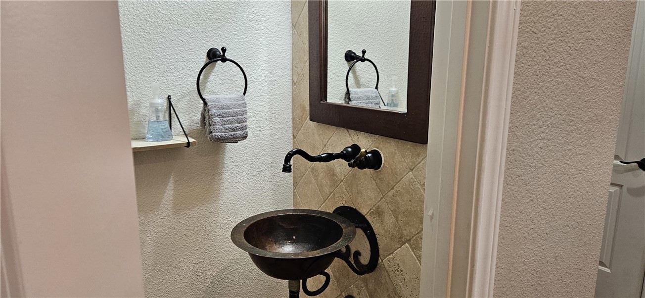 14334 Cruiser Street, Unit 202A Corpus Christi, TX 78418 - Photo 24 of 38 a bathroom with a sink and a mirror