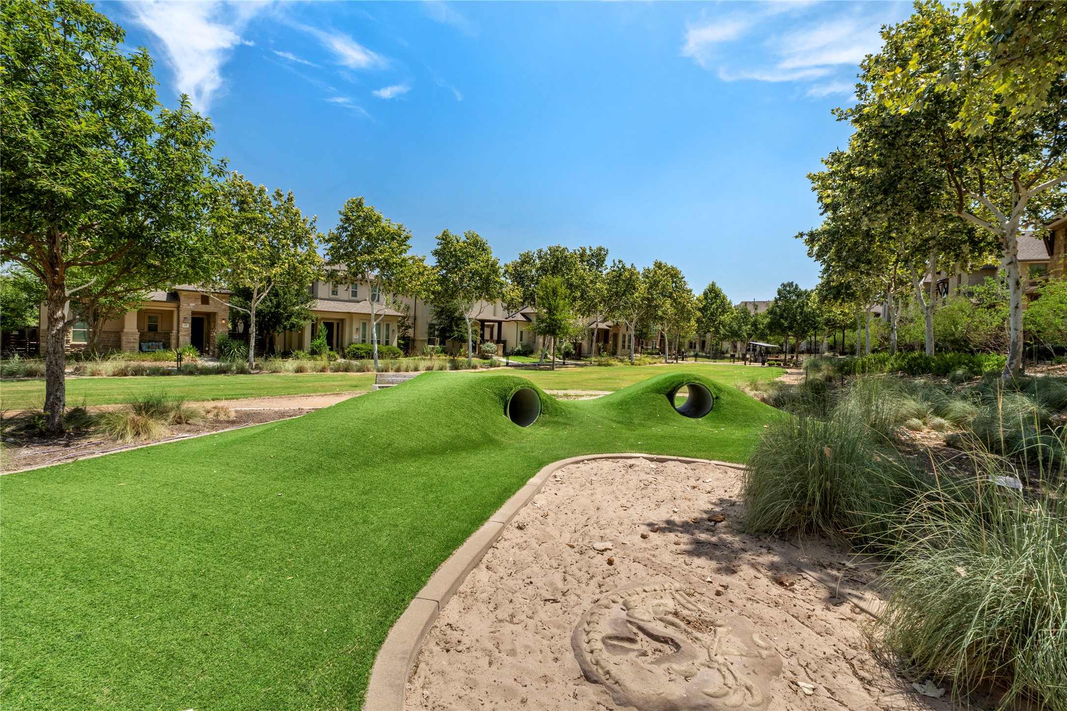 1709 Lawrence Street, Unit 5 Austin, TX 78741 - Photo 5 of 40 Lush grassy common areas and play spaces wind through this peaceful neighborhood setting.