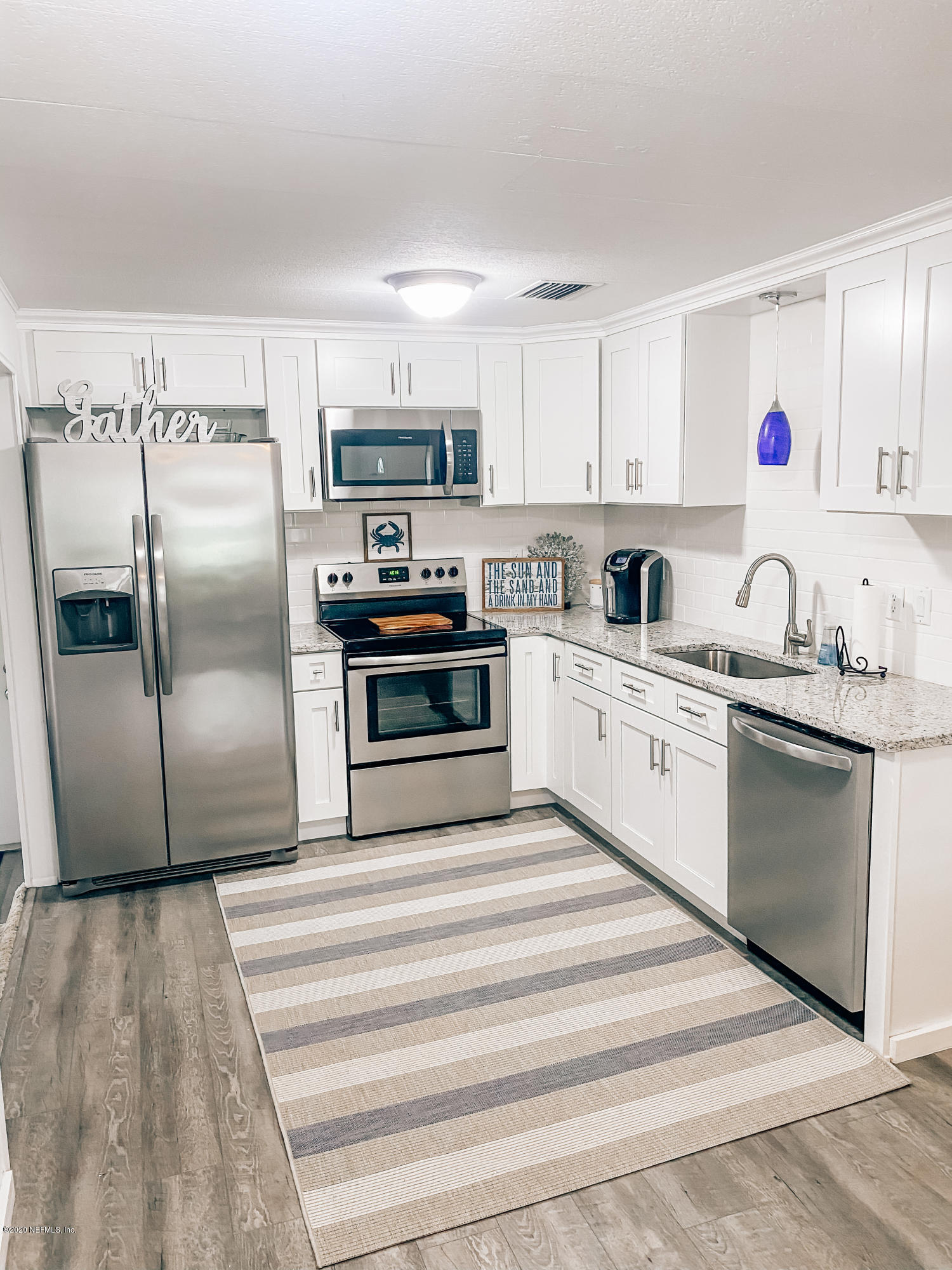 920 Palermo Road St. Augustine, FL 32086 - Photo 4 of 15 a kitchen with stainless steel appliances granite countertop a refrigerator sink and stove