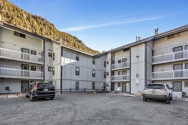 a car parked in front of a white house