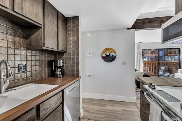 a kitchen with a sink cabinets and appliances