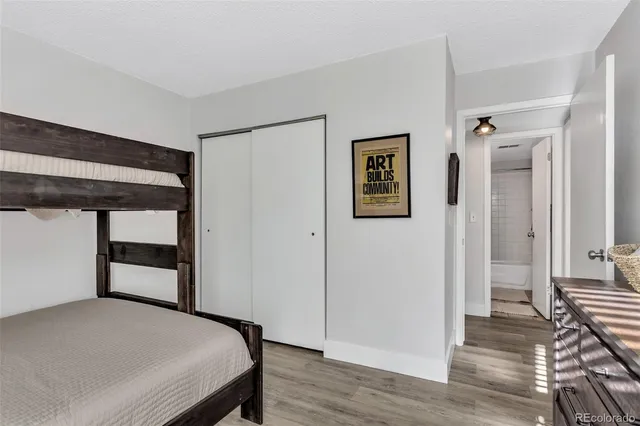 a bedroom with a bed and wooden floor