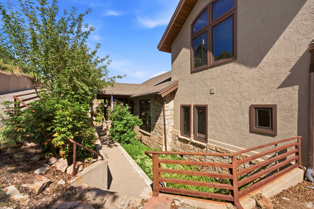 335 Bern Way Midway, UT 84049 - Photo 79 of 88 Stone and stucco exterior with multiple window styles, including a prominent arched window