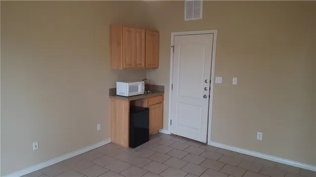 a front view of a house with a garden and patio