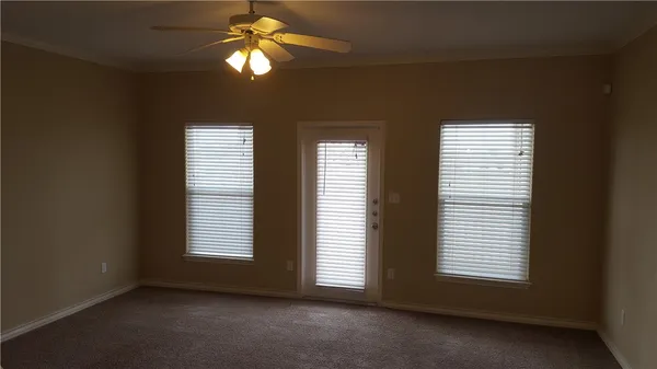 a view of room with a ceiling fan and window