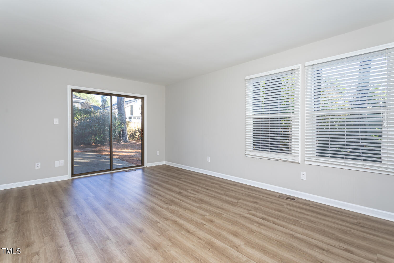 3008 Rue Sans Famille Raleigh, NC 27607 - Photo 11 of 21 a view of an empty room with wooden floor and a window