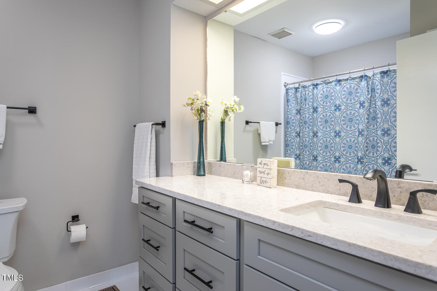 3008 Rue Sans Famille Raleigh, NC 27607 - Photo 12 of 21 a bathroom with a double vanity sink mirror and toilet