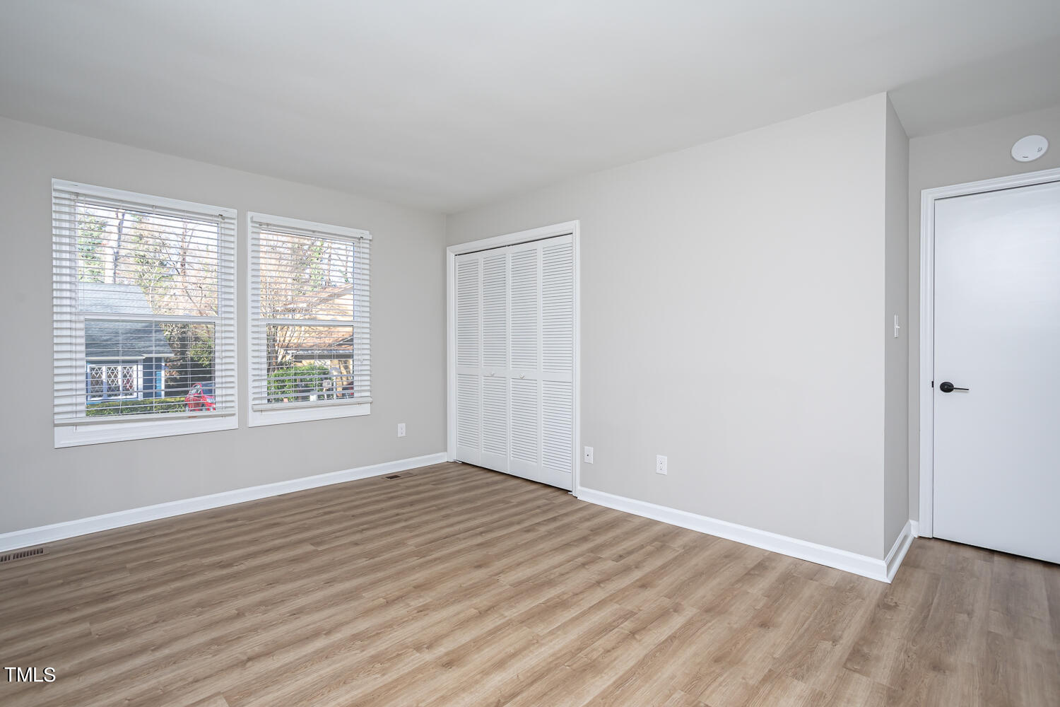 3008 Rue Sans Famille Raleigh, NC 27607 - Photo 14 of 21 a view of an empty room with wooden floor and a window