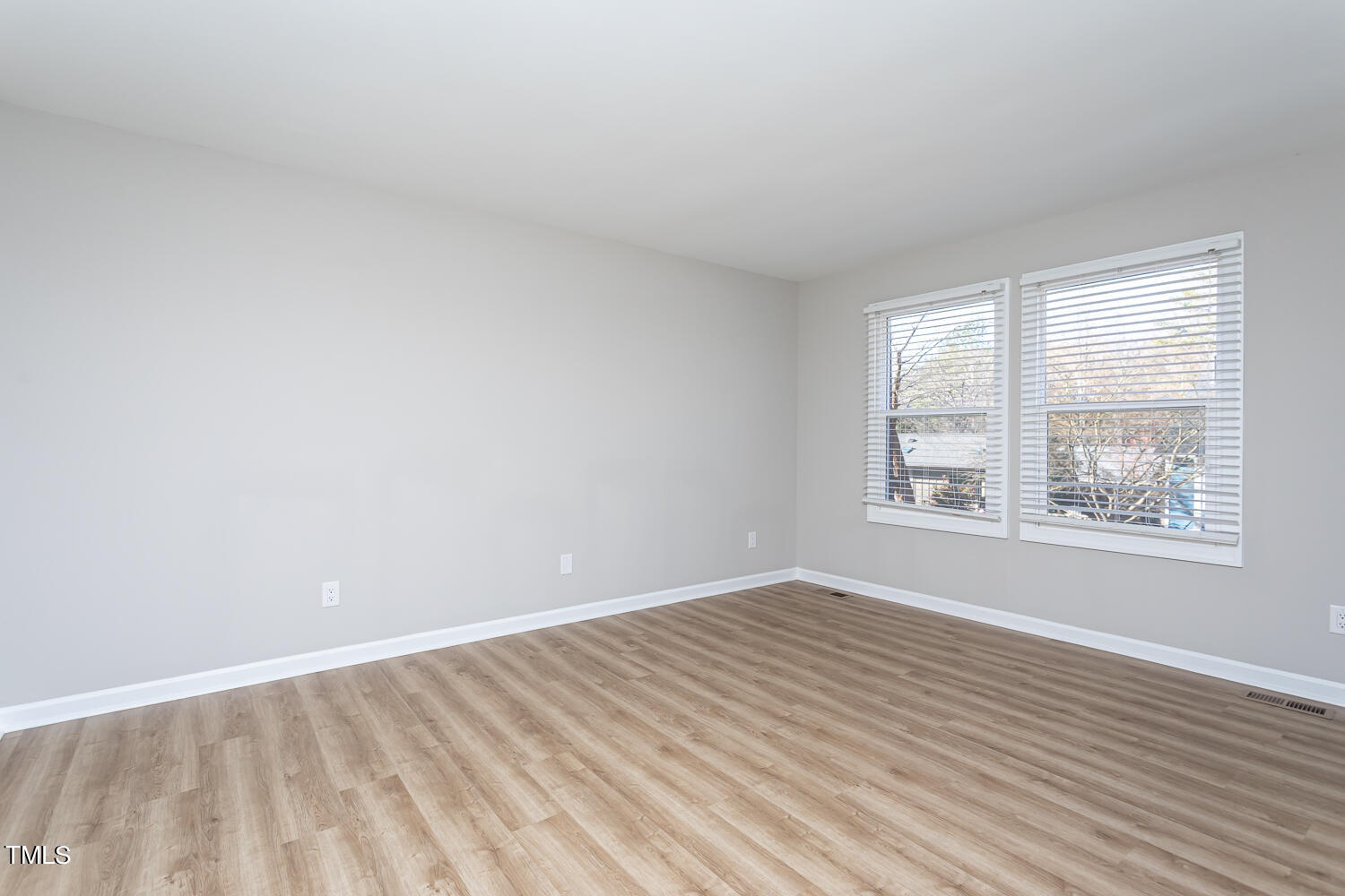 3008 Rue Sans Famille Raleigh, NC 27607 - Photo 15 of 21 an empty room with wooden floor and windows