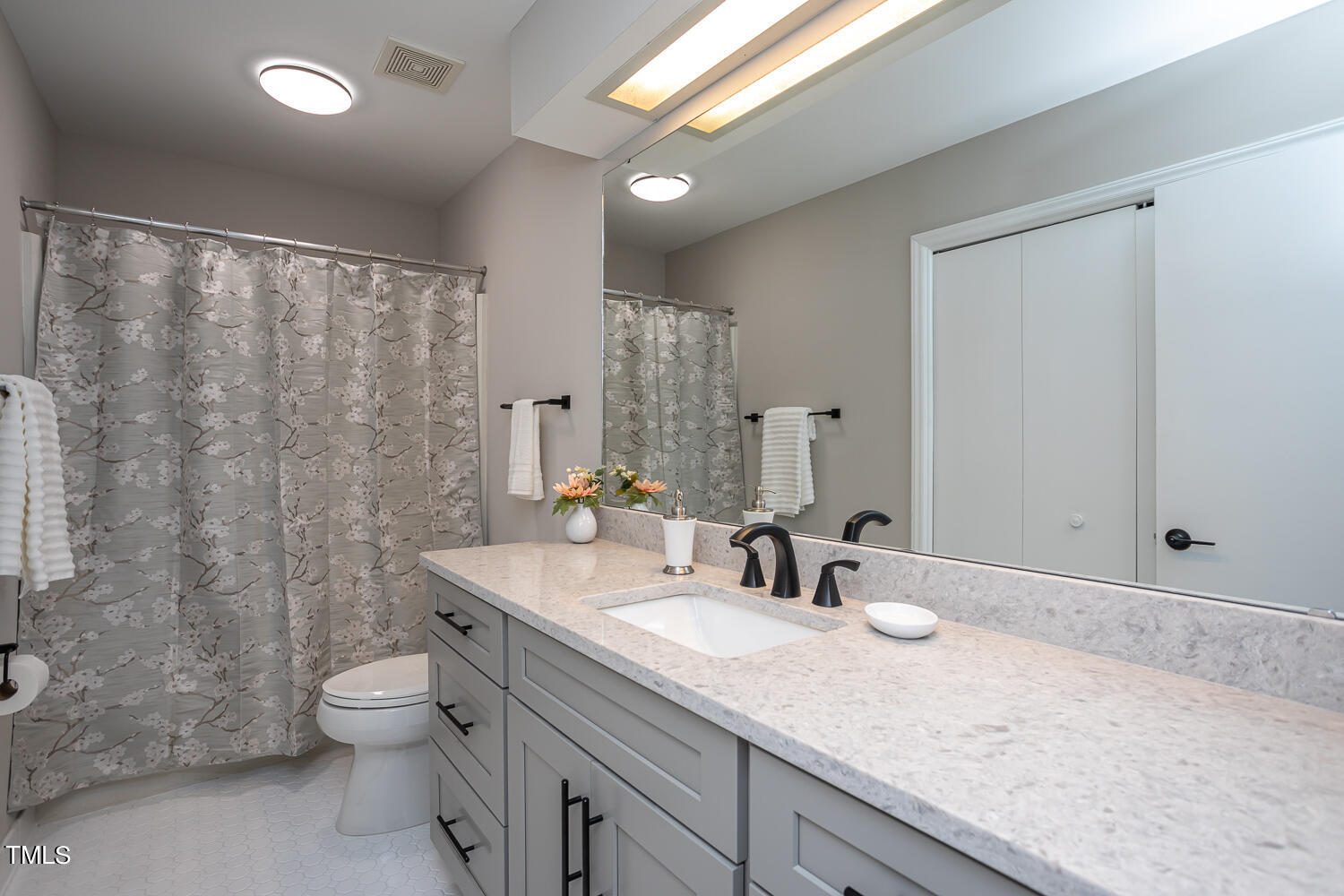 3008 Rue Sans Famille Raleigh, NC 27607 - Photo 16 of 21 a bathroom with a granite countertop sink a toilet and shower