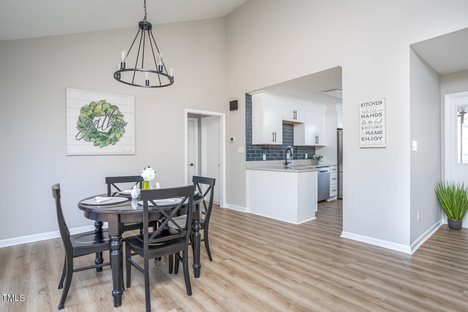 3008 Rue Sans Famille Raleigh, NC 27607 - Photo 4 of 21 a view of a dining room with furniture a chandelier and wooden floor
