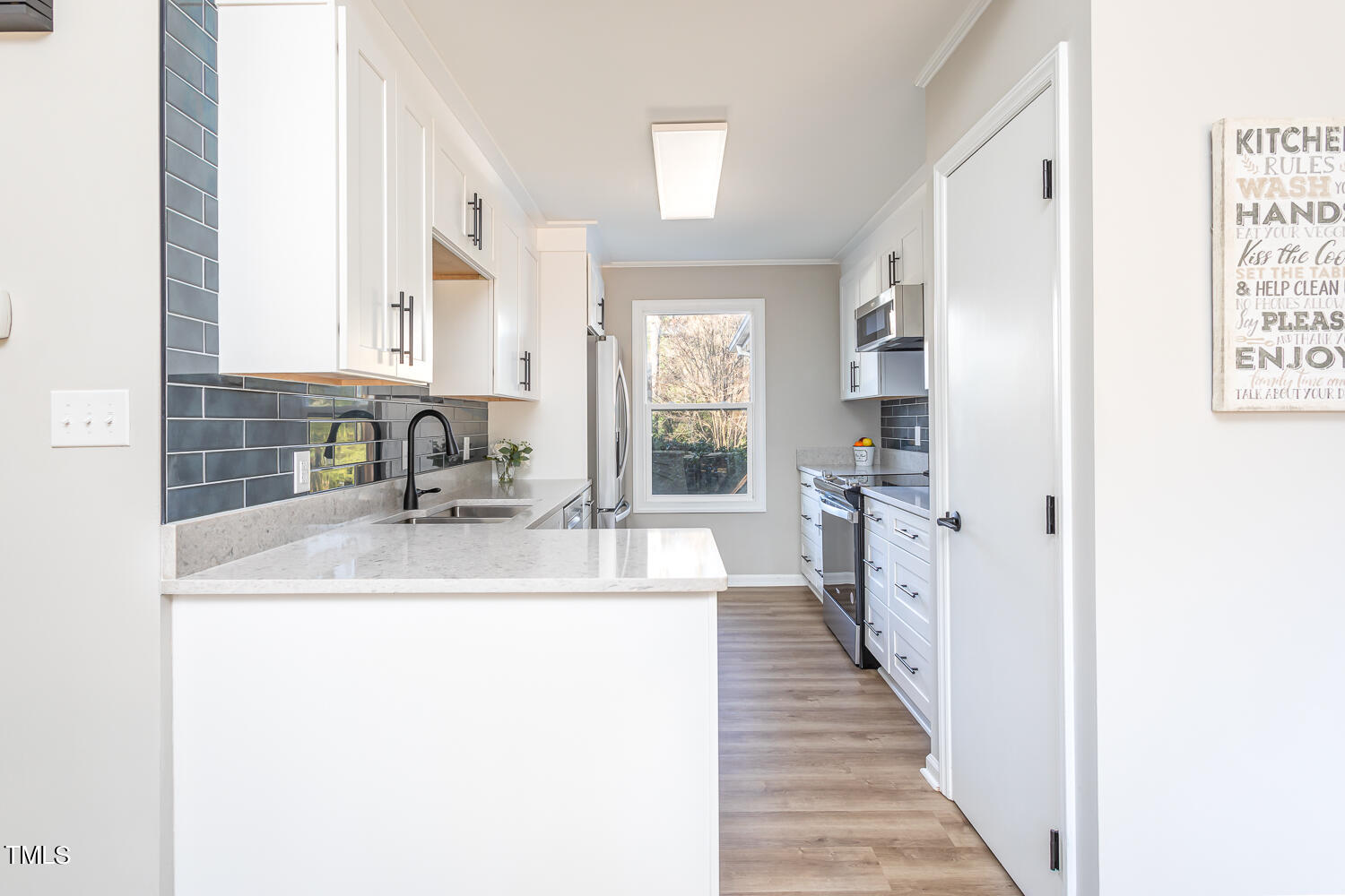 3008 Rue Sans Famille Raleigh, NC 27607 - Photo 5 of 21 a kitchen with sink cabinets and a window