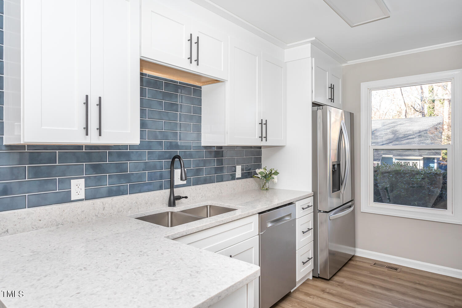 3008 Rue Sans Famille Raleigh, NC 27607 - Photo 6 of 21 a kitchen with stainless steel appliances a sink and a refrigerator