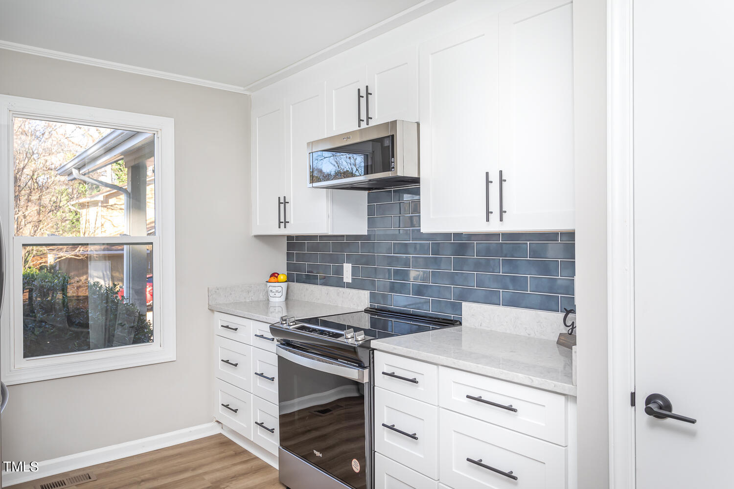 3008 Rue Sans Famille Raleigh, NC 27607 - Photo 8 of 21 a kitchen with stainless steel appliances a stove and a microwave