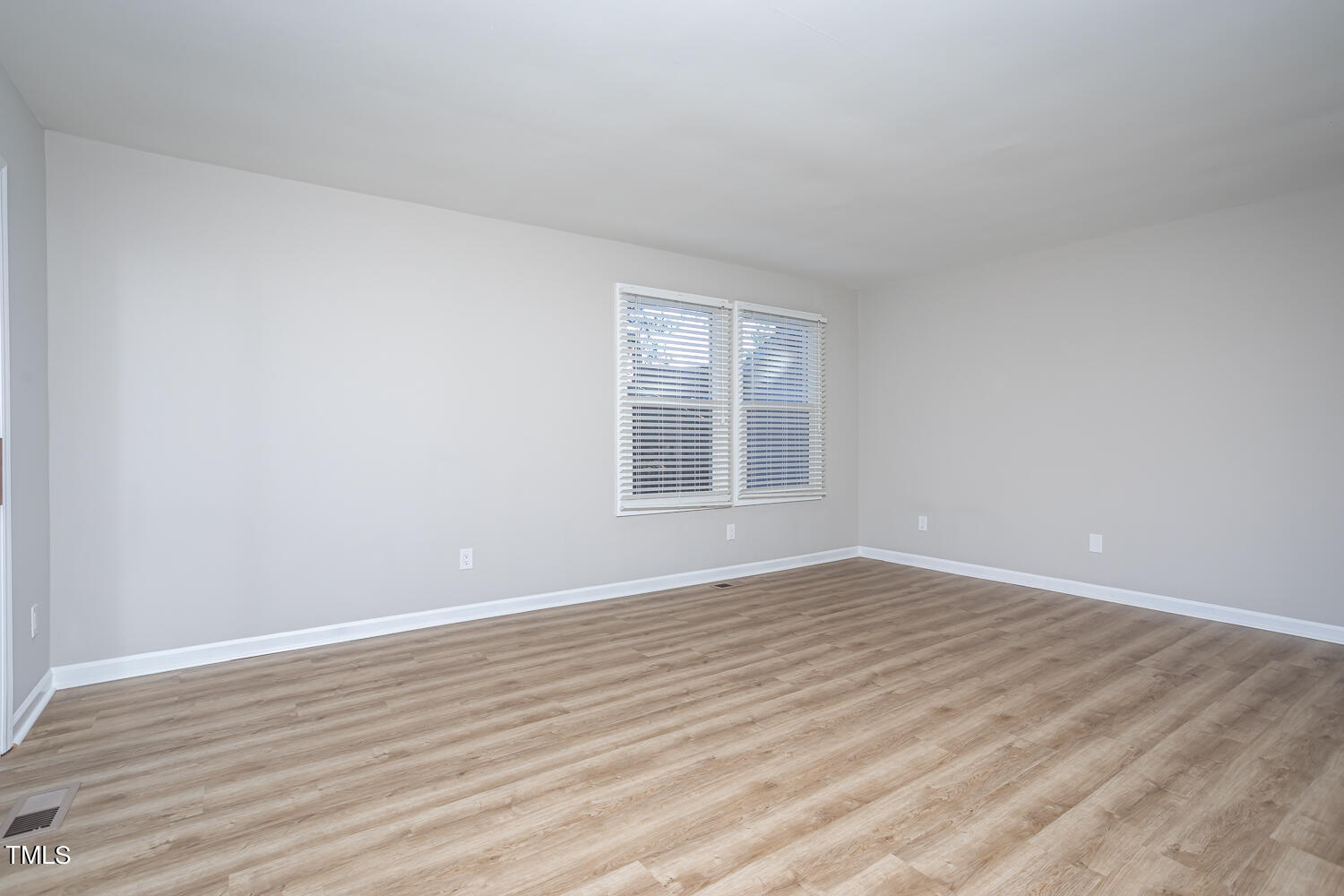 3008 Rue Sans Famille Raleigh, NC 27607 - Photo 10 of 21 a view of an empty room with wooden floor and a window