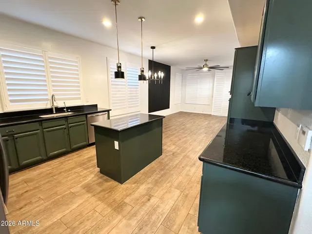 a kitchen with granite countertop cabinets and black appliances