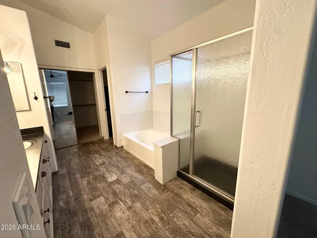 a bathroom with a shower and a sink