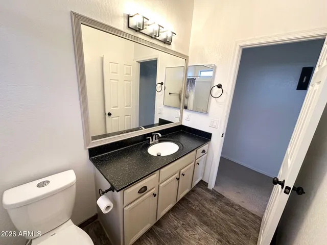 a bathroom with a granite countertop sink and a mirror
