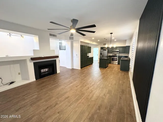 a view of a kitchen with a sink wooden floor and a window
