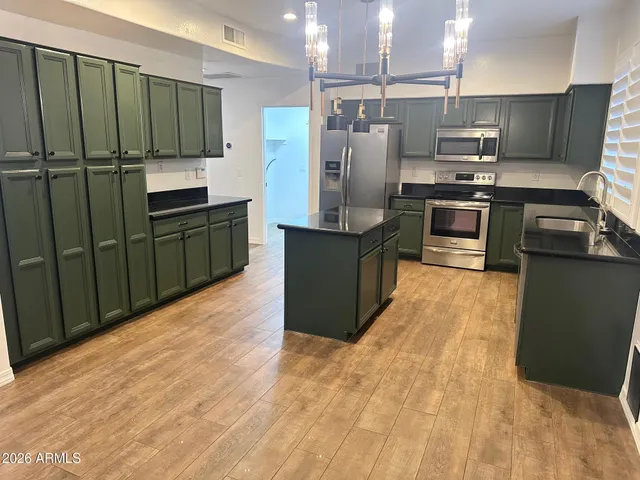 a kitchen with stainless steel appliances a refrigerator and a stove