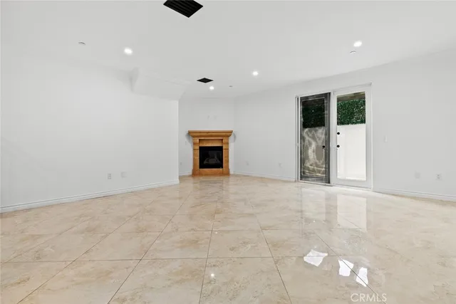 an empty room with closet and mirrors