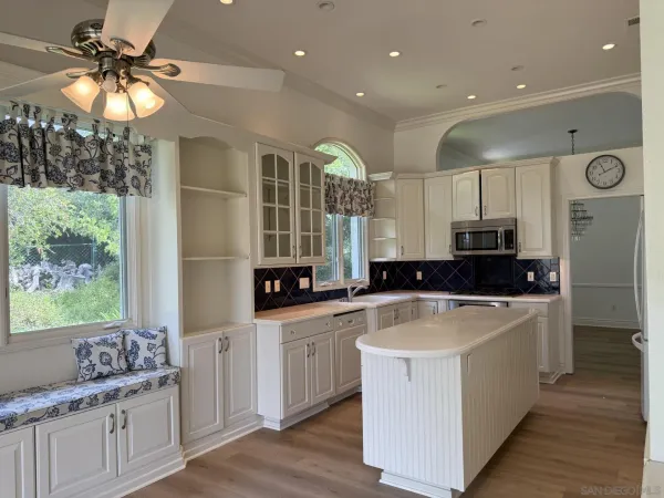 a kitchen with a sink cabinets and window