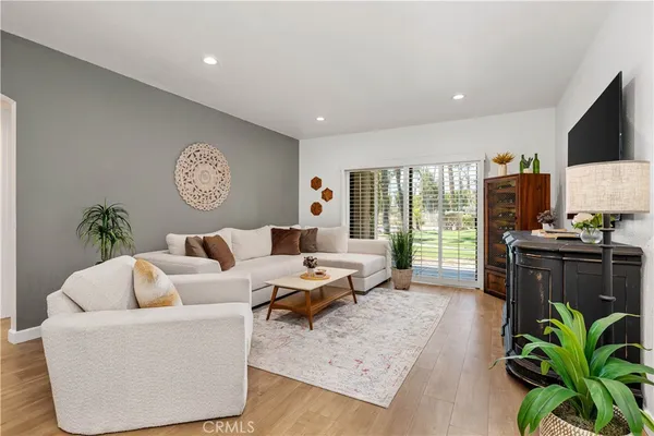 a living room with furniture plant and a large window