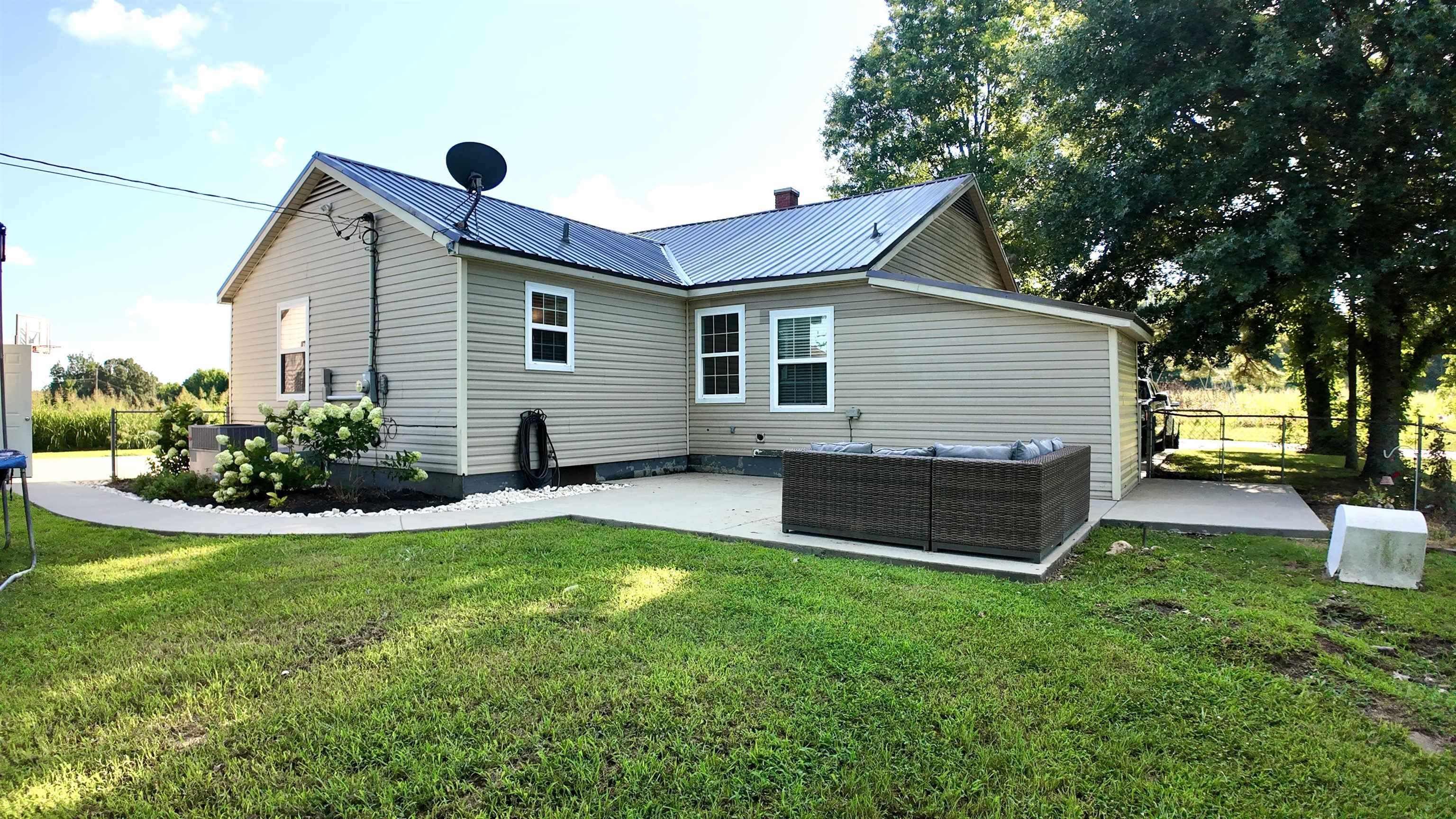 3312 Old Memphis Road Covington, TN 38019 - Photo 11 of 32 Rear view of property with a patio, an outdoor hangout area, and a lawn