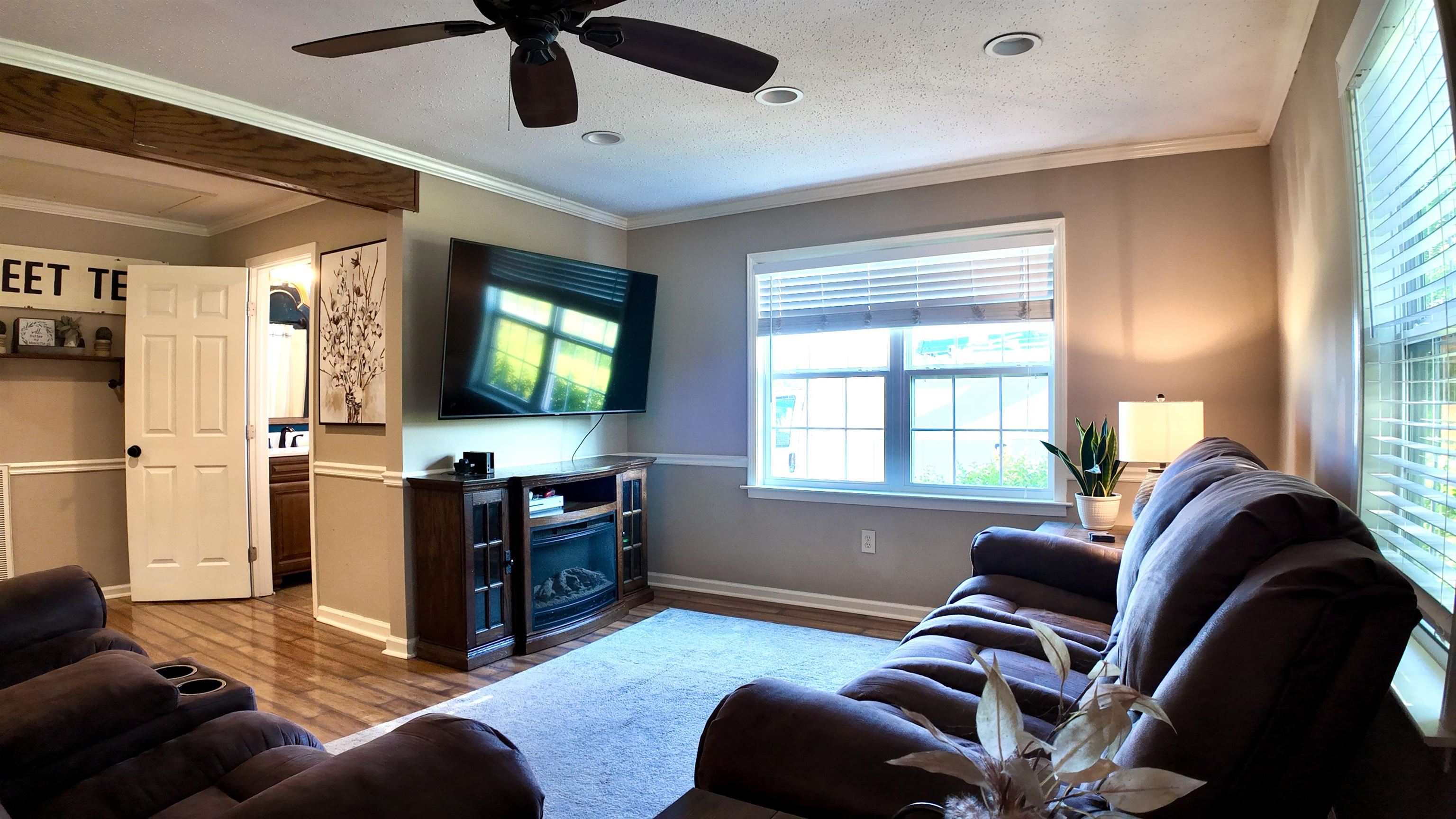3312 Old Memphis Road Covington, TN 38019 - Photo 12 of 32 Living room featuring ceiling fan, crown molding, a textured ceiling, and hardwood / wood-style flooring
