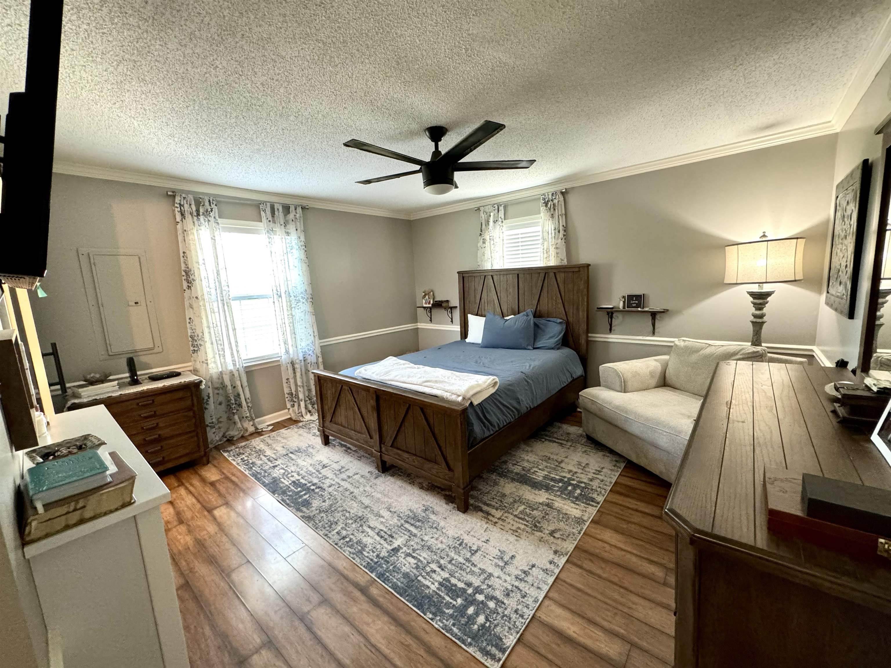 3312 Old Memphis Road Covington, TN 38019 - Photo 20 of 32 Bedroom with a textured ceiling, ceiling fan, hardwood / wood-style floors, and crown molding