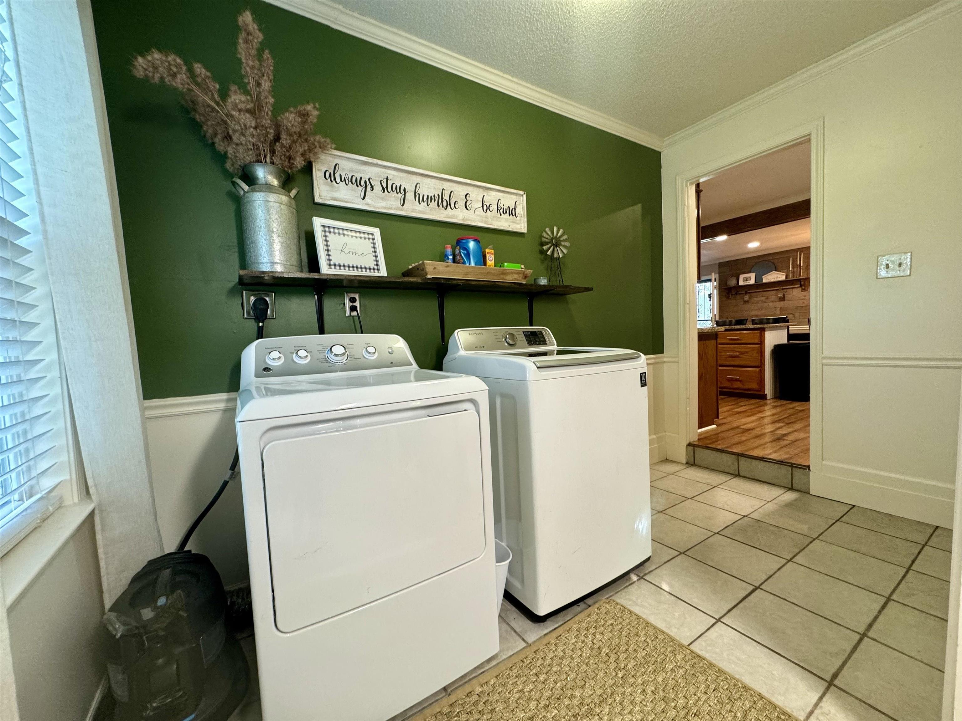 3312 Old Memphis Road Covington, TN 38019 - Photo 25 of 32 Washroom with hardwood / wood-style floors, washer and clothes dryer, a textured ceiling, and ornamental molding