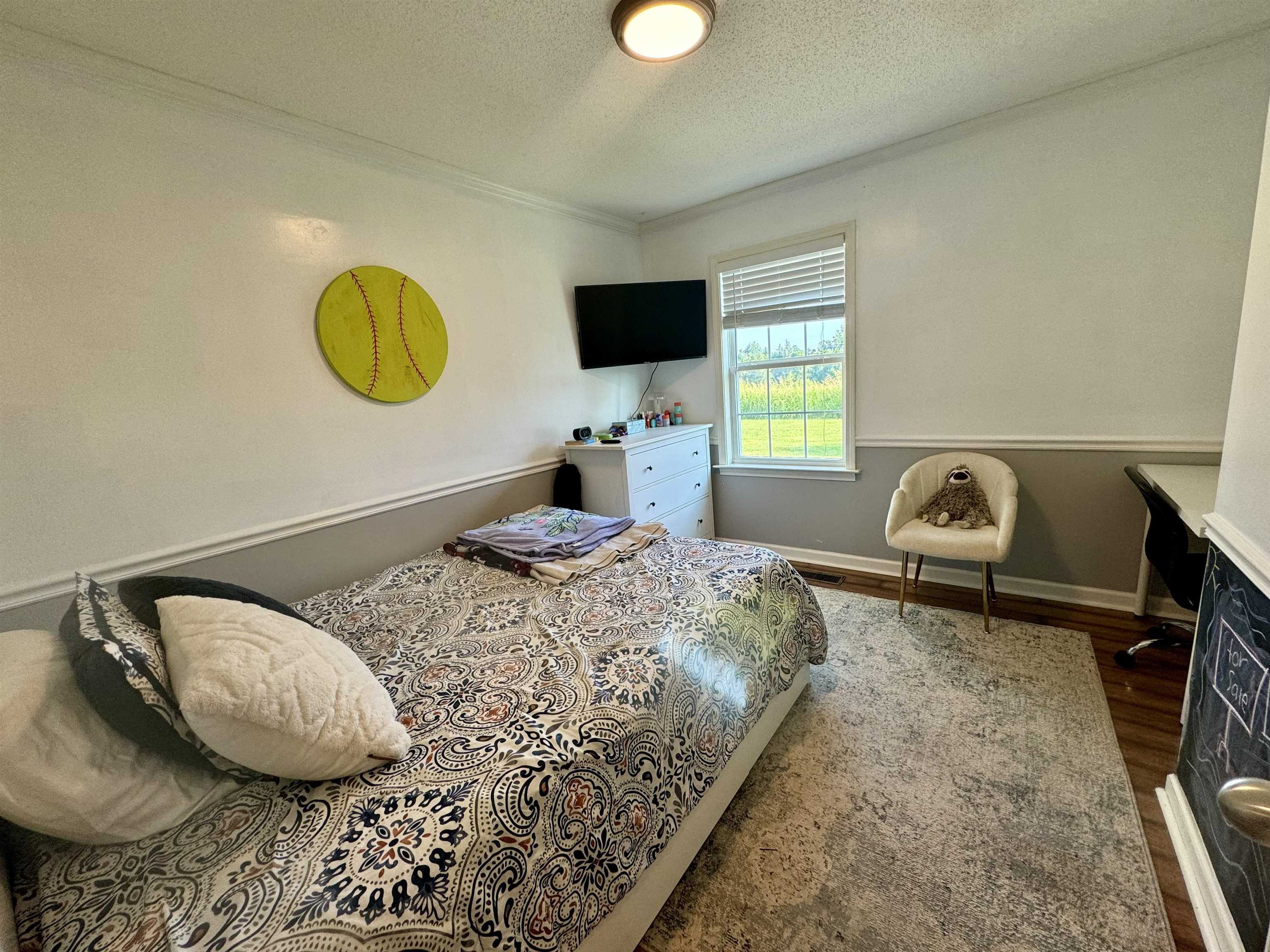 3312 Old Memphis Road Covington, TN 38019 - Photo 28 of 32 Bedroom featuring ornamental molding, a textured ceiling, and hardwood / wood-style flooring
